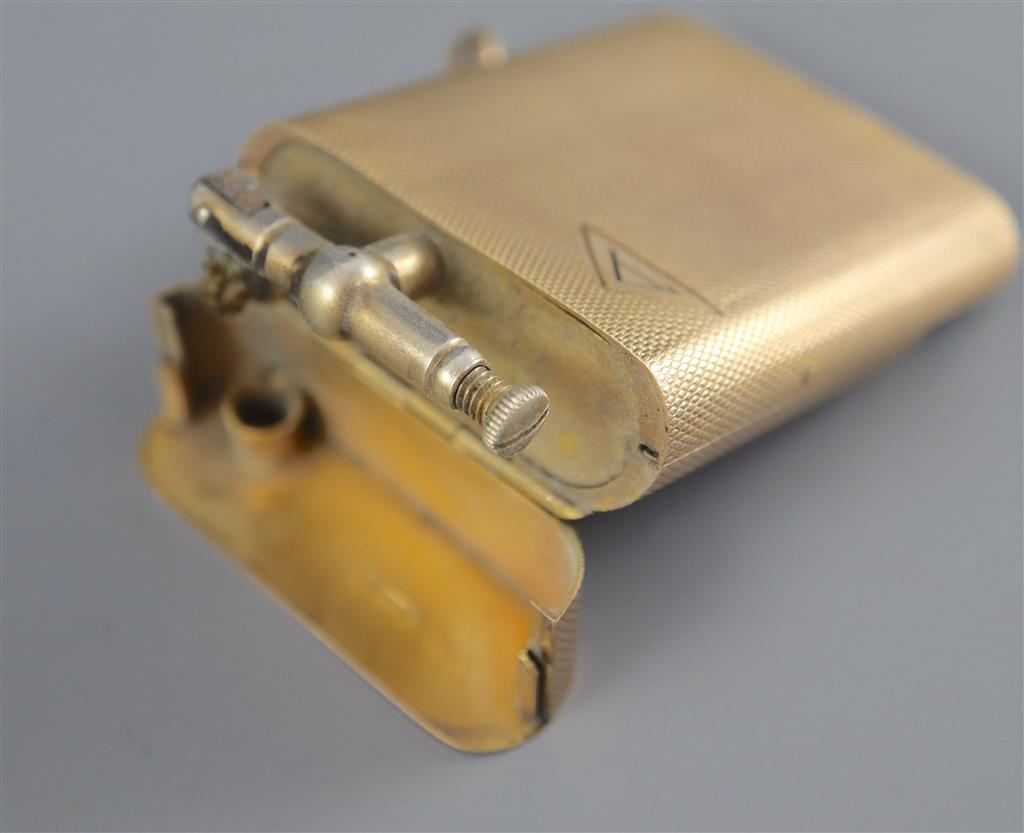 A 1920s engined turned 9ct gold mounted Dunhill lighter, by Finnigans Ltd, London, 1928,